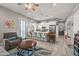 Open concept living space with modern decor, kitchen island, and wood look flooring at 18970 W Desert Hills Dr, Surprise, AZ 85388