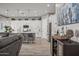 Open living space with seamless flow into the modern kitchen, featuring white cabinetry at 18970 W Desert Hills Dr, Surprise, AZ 85388