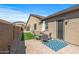 Charming outdoor patio with dining set and manicured artificial turf at 18970 W Desert Hills Dr, Surprise, AZ 85388