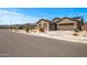 Street view of a well-maintained home with desert landscaping, a two-car garage, and a neighborhood setting at 18970 W Desert Hills Dr, Surprise, AZ 85388