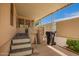 Back porch has stairs leading to the yard and a comfortable sitting area at 201 S Greenfield Rd # 129, Mesa, AZ 85206