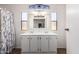 A bathroom has a large mirror above a double vanity with a glass door shower to the side at 201 S Greenfield Rd # 129, Mesa, AZ 85206