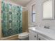 Functional bathroom featuring a vanity, toilet, and tub with shower curtain at 201 S Greenfield Rd # 129, Mesa, AZ 85206