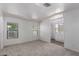 A bright bedroom with a window and a view of the bathroom that has a shower and a white vanity at 201 S Greenfield Rd # 129, Mesa, AZ 85206