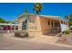 Charming home with covered parking, mature landscaping and desirable curb appeal at 201 S Greenfield Rd # 129, Mesa, AZ 85206