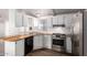 A bright kitchen features white cabinets, wooden countertops, and stainless steel appliances at 201 S Greenfield Rd # 129, Mesa, AZ 85206