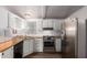 The kitchen has modern appliances, stainless steel sink, wood countertops, and light cabinets at 201 S Greenfield Rd # 129, Mesa, AZ 85206