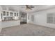 Sun-filled living room featuring neutral carpet, light walls, and open floorplan at 201 S Greenfield Rd # 129, Mesa, AZ 85206