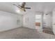 Sun-filled living room with light walls, neutral carpet, and doorway to other rooms at 201 S Greenfield Rd # 129, Mesa, AZ 85206