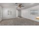 Bright and airy living room with neutral carpet, light walls, and an open doorway at 201 S Greenfield Rd # 129, Mesa, AZ 85206