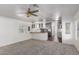 Living room showing neutral carpet, light walls, and view of the kitchen at 201 S Greenfield Rd # 129, Mesa, AZ 85206