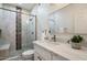 Modern bathroom boasts a glass-enclosed shower, decorative tile, and elegant vanity with quartz countertop at 20100 N 78Th Pl # 3084, Scottsdale, AZ 85255