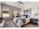 Comfortable bedroom featuring a ceiling fan, plush bedding, and a modern nightstand with stylish lamps at 20100 N 78Th Pl # 3084, Scottsdale, AZ 85255
