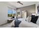 Cozy bedroom features a ceiling fan, a stylish mirror, and a well-lit view from the large window at 20100 N 78Th Pl # 3084, Scottsdale, AZ 85255