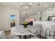 Open-concept dining area with stylish lighting, opening to living space and balcony at 20100 N 78Th Pl # 3084, Scottsdale, AZ 85255
