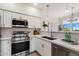Bright kitchen with stainless steel appliances and white cabinets and countertops with modern fixtures at 20100 N 78Th Pl # 3084, Scottsdale, AZ 85255