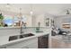 Modern kitchen with white marble countertops, stainless steel appliances, and open view into the living room at 20100 N 78Th Pl # 3084, Scottsdale, AZ 85255