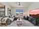 Inviting living room with a comfortable sectional sofa, stylish decor, and a modern ceiling fan at 20100 N 78Th Pl # 3084, Scottsdale, AZ 85255
