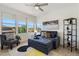 Stylish living room featuring a convertible sofa, modern shelving, and large windows providing ample natural light at 20100 N 78Th Pl # 3084, Scottsdale, AZ 85255