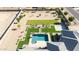 Aerial view of the backyard with manicured lawns, desert landscaping, and sparkling pool at 20213 W Amelia Ave, Buckeye, AZ 85396