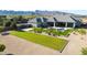 Aerial view showing the expansive lawn, inviting pool, and desert landscaping, set against a mountain backdrop at 20213 W Amelia Ave, Buckeye, AZ 85396
