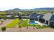 Aerial view of the home showcasing the lush lawn, sparkling pool, and desert landscaping, with mountain views at 20213 W Amelia Ave, Buckeye, AZ 85396