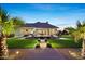 A backyard patio offers an outdoor grilling area, dining and lounge area, and well-manicured lawn at 20213 W Amelia Ave, Buckeye, AZ 85396