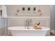 Soaking tub featuring wall trim, decor, and brushed nickel plumbing fixtures at 20213 W Amelia Ave, Buckeye, AZ 85396