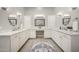 Elegant bathroom featuring dual sinks, white cabinetry, and vanity at 20213 W Amelia Ave, Buckeye, AZ 85396