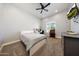 Bedroom featuring carpeted floors, a modern ceiling fan, and a TV mounted on the wall at 20213 W Amelia Ave, Buckeye, AZ 85396