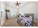 Bright bedroom with a large window, carpet flooring, and television on wall at 20213 W Amelia Ave, Buckeye, AZ 85396