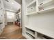 View of hallway with built-in storage and desk areas, featuring hardwood floors at 20213 W Amelia Ave, Buckeye, AZ 85396