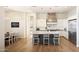 Modern kitchen with white cabinets, center island, stainless steel appliances, and stylish pendant lighting at 20213 W Amelia Ave, Buckeye, AZ 85396