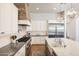 Spacious kitchen featuring a center island, stainless steel appliances, and custom cabinets at 20213 W Amelia Ave, Buckeye, AZ 85396