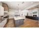 Bright, open kitchen with large island, stainless steel appliances, and light countertops overlooking a great room at 20213 W Amelia Ave, Buckeye, AZ 85396