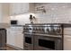 The gourmet kitchen features stainless appliances, subway tile backsplash, and a pot filler faucet at 20213 W Amelia Ave, Buckeye, AZ 85396
