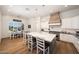 Bright kitchen with white cabinetry, stainless steel appliances, and a large center island with seating at 20213 W Amelia Ave, Buckeye, AZ 85396