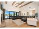 Open-concept living room boasts high ceilings, wood beams, a fireplace, and seamless indoor-outdoor flow at 20213 W Amelia Ave, Buckeye, AZ 85396