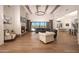 Open-concept living room with hardwood floors, fireplace, high ceilings with wooden beams and chandelier at 20213 W Amelia Ave, Buckeye, AZ 85396