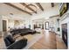 Spacious living room with a fireplace, vaulted ceilings, wood beams, and chandelier at 20213 W Amelia Ave, Buckeye, AZ 85396