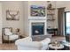 Living room with hardwood floors, brick fireplace, and a wall-mounted television at 20213 W Amelia Ave, Buckeye, AZ 85396