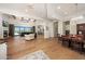 Expansive living room featuring hardwood floors, fireplace, wood beams, and access to an outdoor patio at 20213 W Amelia Ave, Buckeye, AZ 85396
