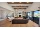 Spacious living area with vaulted ceilings, fireplace, hardwood floors, and access to the outdoor patio at 20213 W Amelia Ave, Buckeye, AZ 85396