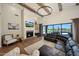 Living room featuring a fireplace, vaulted ceilings with wooden beams, and backyard views through sliding glass doors at 20213 W Amelia Ave, Buckeye, AZ 85396
