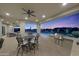 Outdoor dining area featuring built-in grill, bar area, and pool views at 20213 W Amelia Ave, Buckeye, AZ 85396