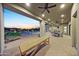 Spacious covered patio with brick pavers, ceiling fans, and outdoor seating areas at 20213 W Amelia Ave, Buckeye, AZ 85396