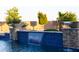 Pool with decorative waterfall feature framed with desert landscaping at 20213 W Amelia Ave, Buckeye, AZ 85396