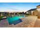 Backyard pool featuring basketball hoop and waterfall features surrounded by pavers at 20213 W Amelia Ave, Buckeye, AZ 85396