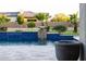 Backyard pool with unique waterfall feature and desert landscaping surrounding the space at 20213 W Amelia Ave, Buckeye, AZ 85396