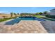 Inviting pool with built-in water features and basketball hoop, surrounded by well-manicured landscaping at 20213 W Amelia Ave, Buckeye, AZ 85396